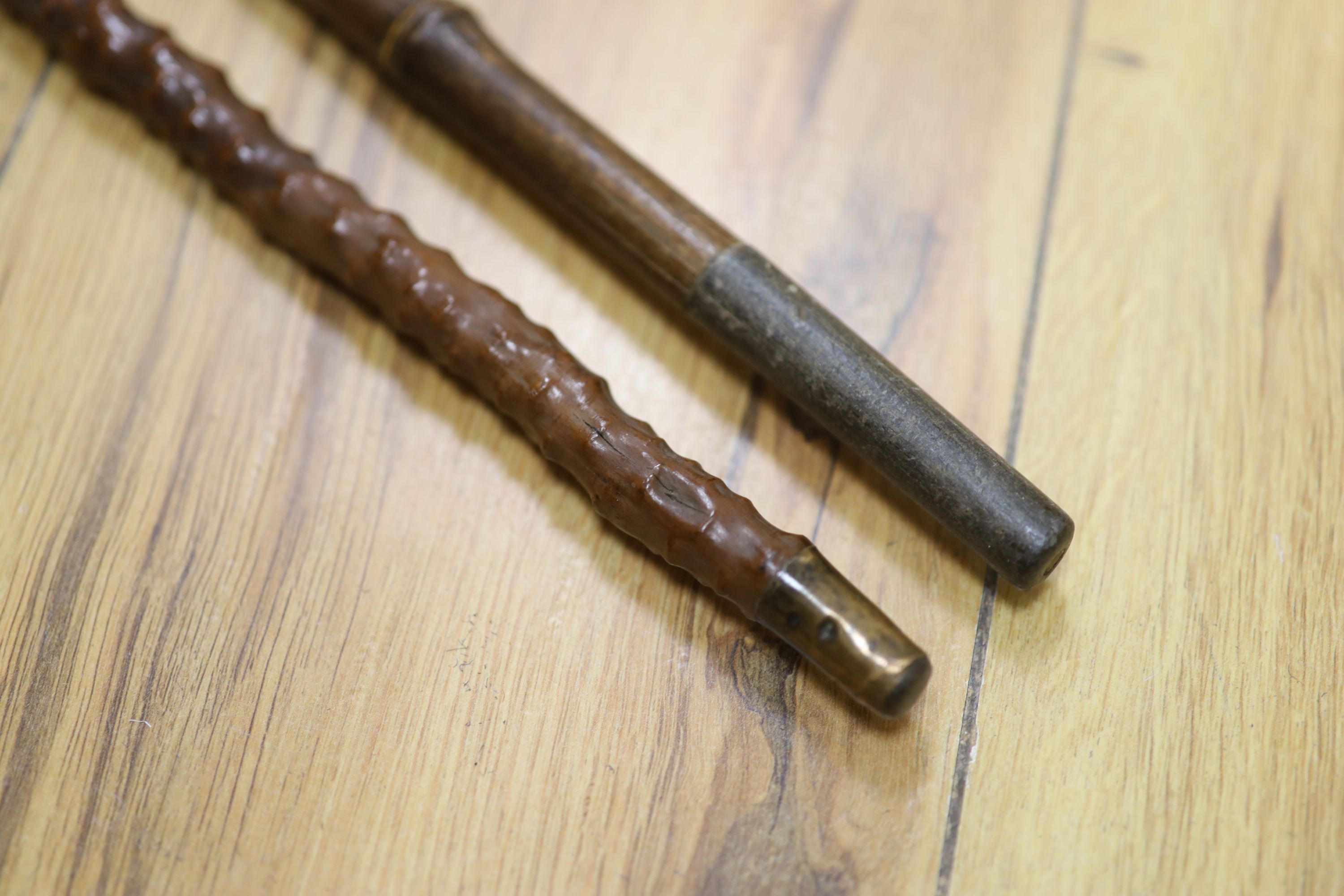 A yellow metal mounted bamboo cane and a gilt metal mounted cane
